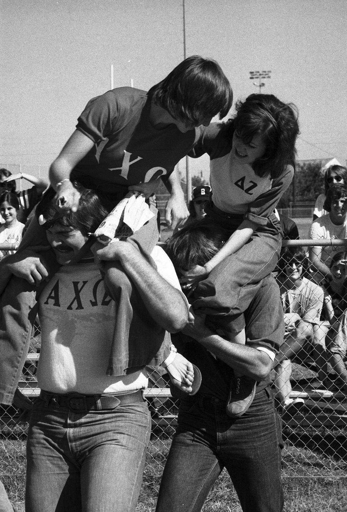 Oct. 19, 1974: Cindy Smith, on the shoulders of John Powell, left, scraps with Kathleen Moore, who is on Mike Nelson, in an attempt to break an egg taped to foreheads of the two men. Competition was in the UTA Winter Olympics at University of Texas at Arlington.