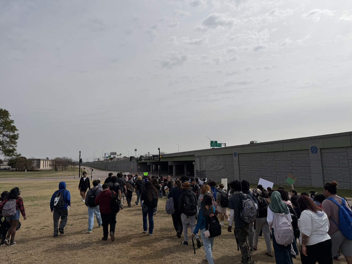 Students started at Euless City Hall before marching down Highway 183 on Friday during the anti-ICE walk out protest.