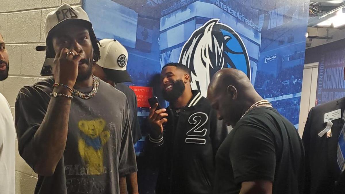 Free agent receiver Odell Beckham, center, chats on the phone outside the Mavs locker room following Monday’s victory over the Suns as he waits with Cowboys linebacker Micah Parsons and cornerback Trevon Diggs.