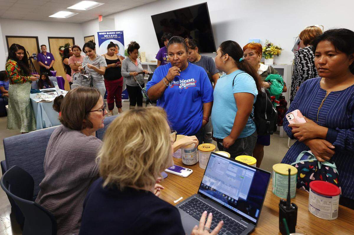 Families wait their turn for free diapers and formula during Community Crossroads’ weekly distribution on Monday, July 31, 2023.