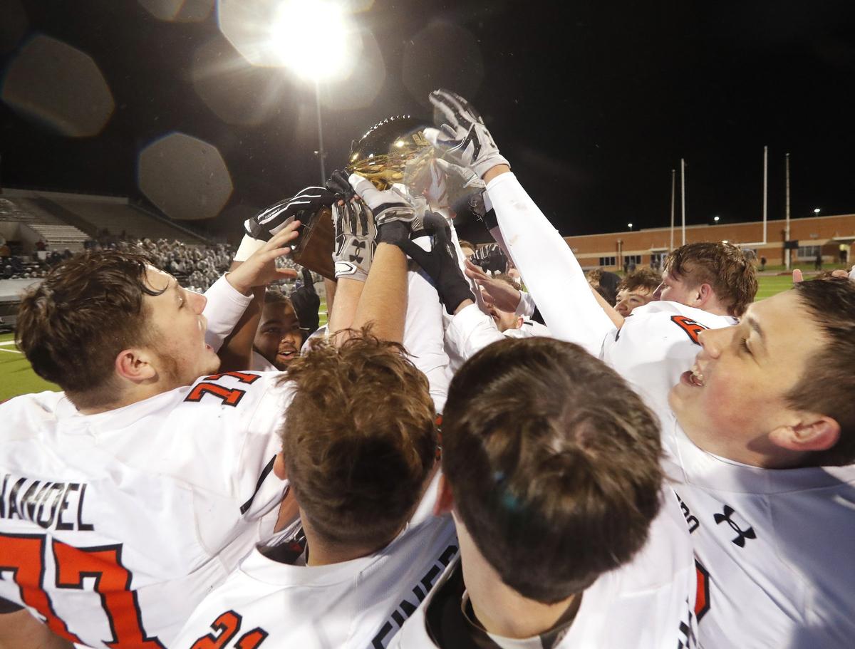 Aledo players get a hand on the trophy after a high school 5A Division II Quarter Finals football playoff game at Northwest ISD Stadium, Justin, Texas, Saturday, Dec. 08, 2018. Aledo handed Frisco Reedy their first loss of the season at 26-16. (Star-Telegram Bob Booth)
