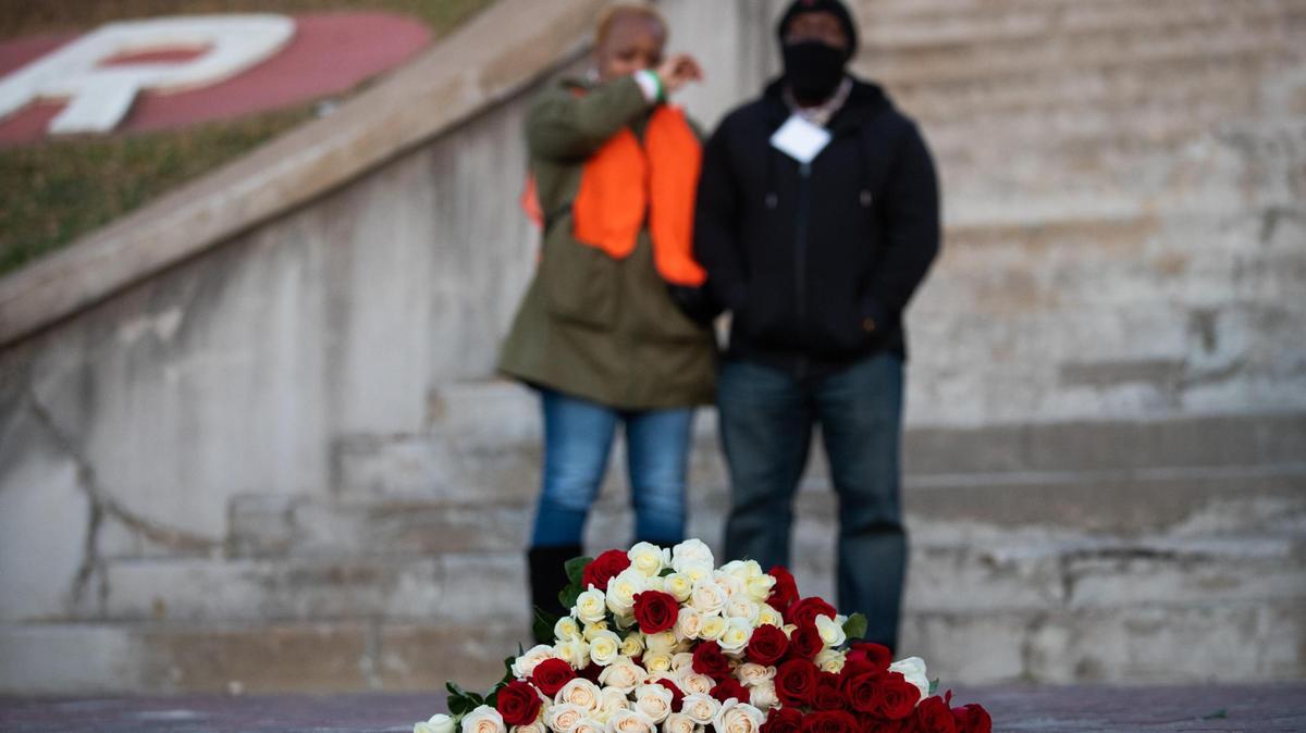 Timeka Gordon and Fred Rouse III stand behind 100 roses left at the site where Rouse’s grandfather Fred Rouse was attacked 100 years ago at the Fort Worth Stockyards. Fred Rouse was later abducted from a hospital and lynched on Dec. 11, 1921.