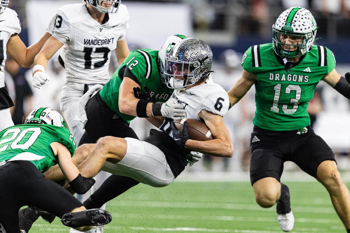 Vandegrift wide receiver George Farley (6) is tackled by Southlake Carroll defensive backs Jacob Montes (20), Marcus Brouse (12), and Zac Hays (13) on a kick off return in the first half of the UIL 6A Division II championship game at AT&T Stadium in Arlington on Saturday, Dec. 21, 2024.