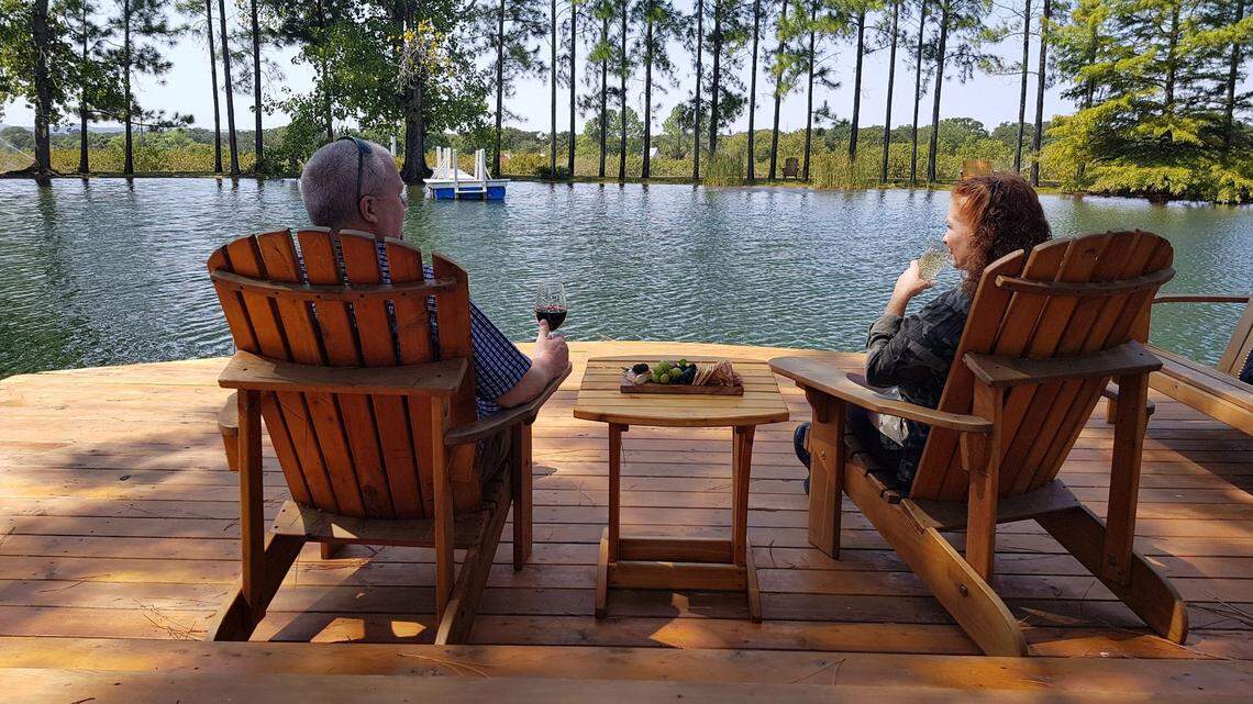 A couple enjoys the pond at Fischer and Wieser’s Das Peach Haus in Fredericksburg, Texas. (Fischer and Wieser/TNS)