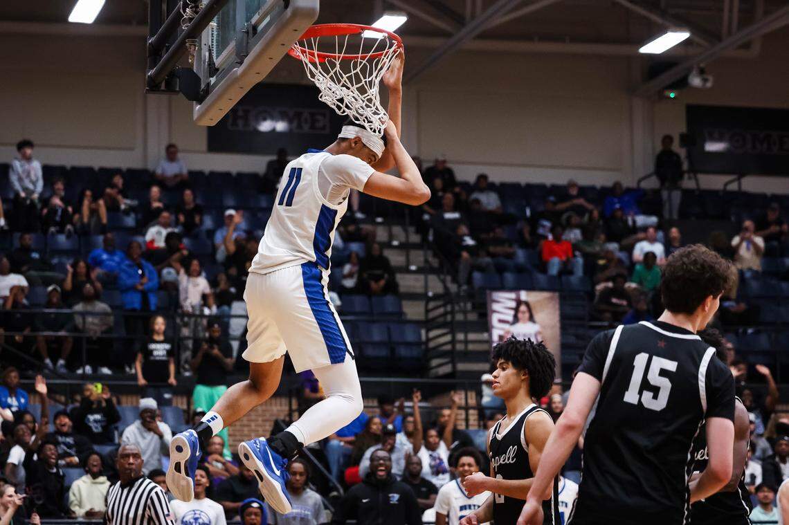 North Crowley forward Trey Hall (11) hangs on the rim after making a dunk in a UIL 6A D1 regional semifinal at Timberview High School in Arlington, Texas, Tuesday, March 3, 2026.