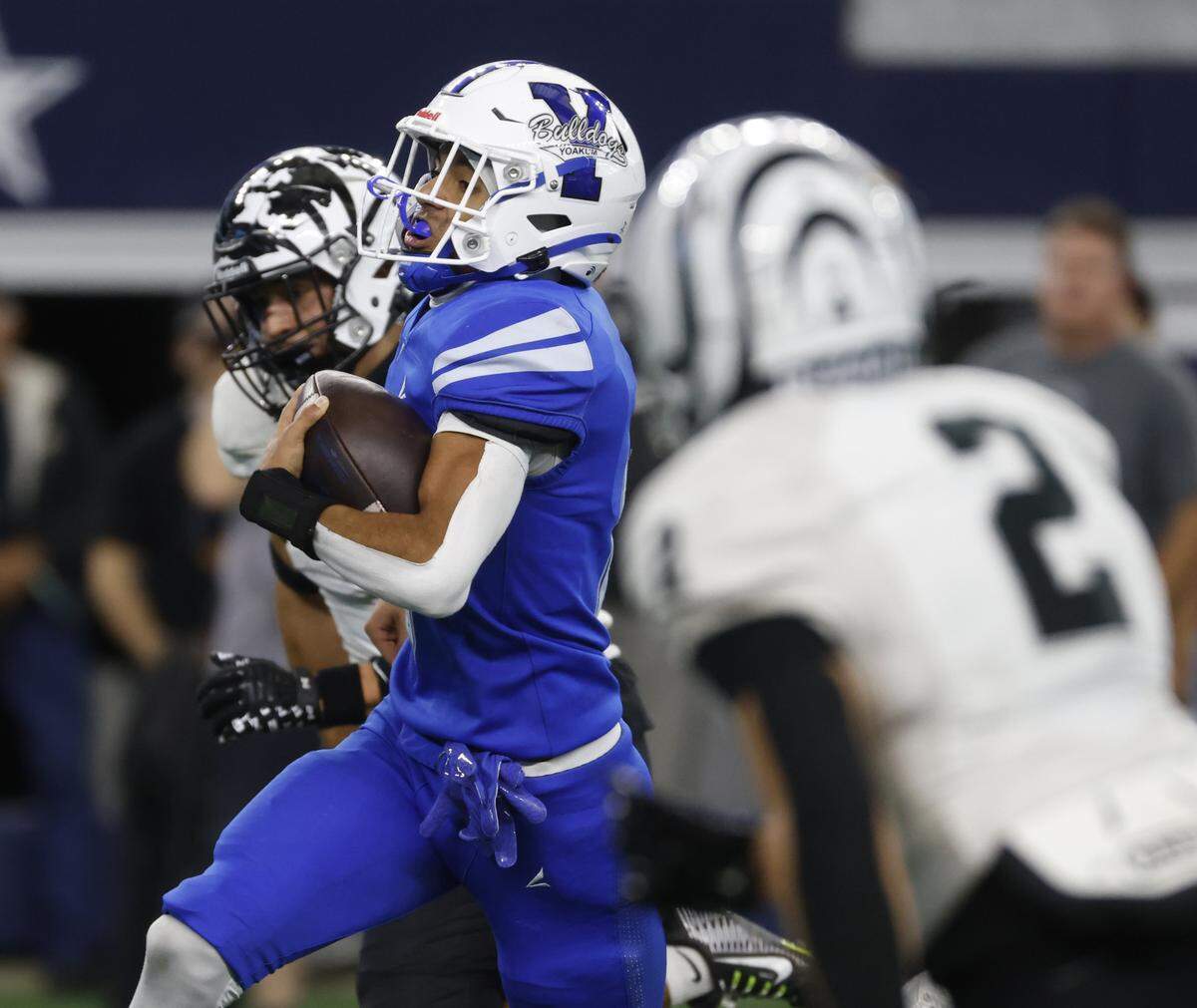 Yoakum wide receiver Jace Morales (0) splits the defense of Grandview corner backs Kason Sanders (2) and Preston Davis (3) for a touchdown during the first half of a UIL Class 3A Division I championship game on Thursday Dec. 18, 2025 at AT&T Stadium in Arlington, Texas.