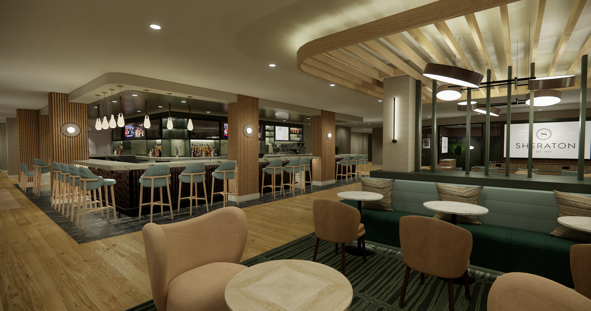 A rendering of the hotel's upgraded bar and lobby area features a high-top bar counter to the left with several bar stool chairs. The the right are several smaller tables in front of a booth decorated with accent pillows. 