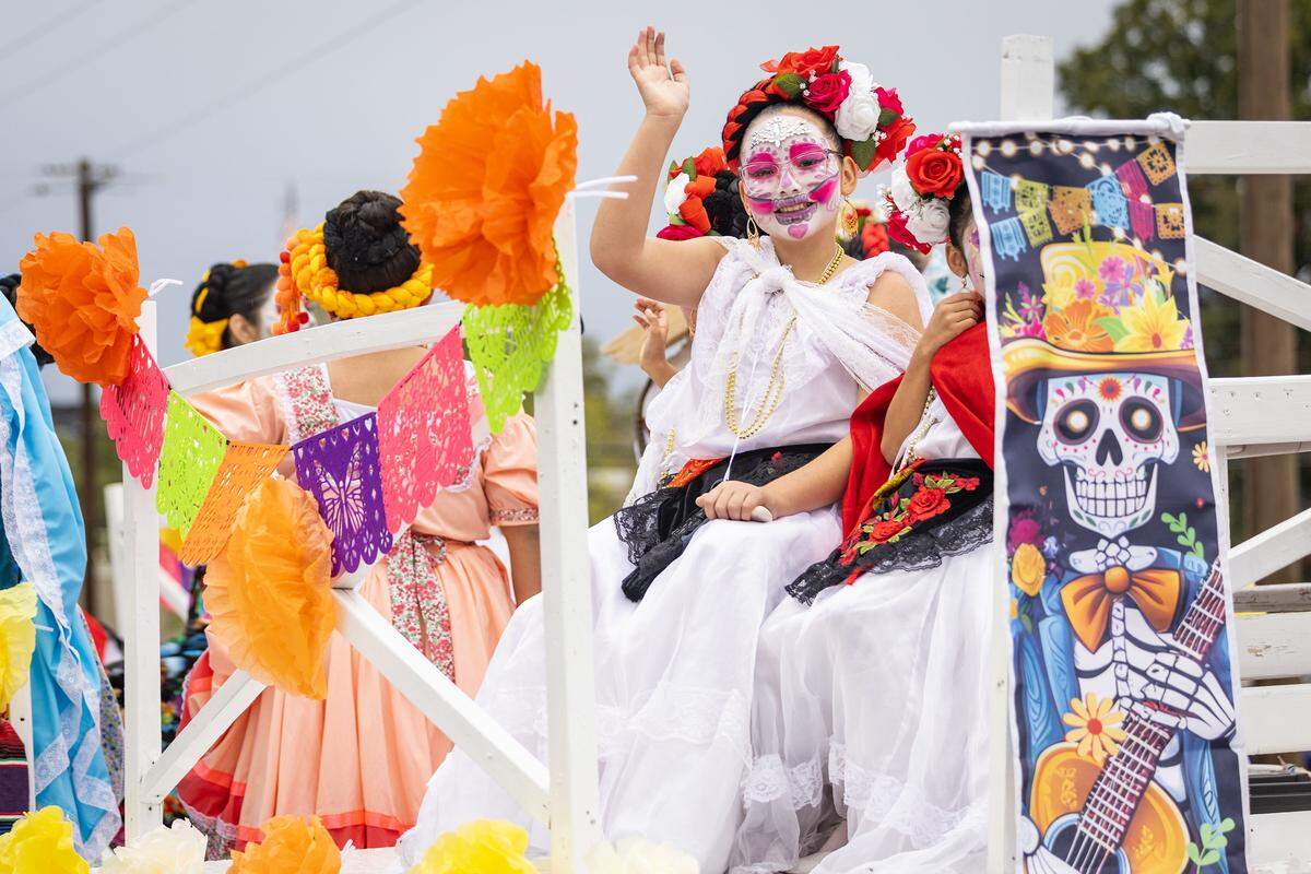 Parade participants ride down Ellis Avenue for the Dia De Los Muertos Parade in Northside Fort Worth on Saturday, Nov. 1, 2025.