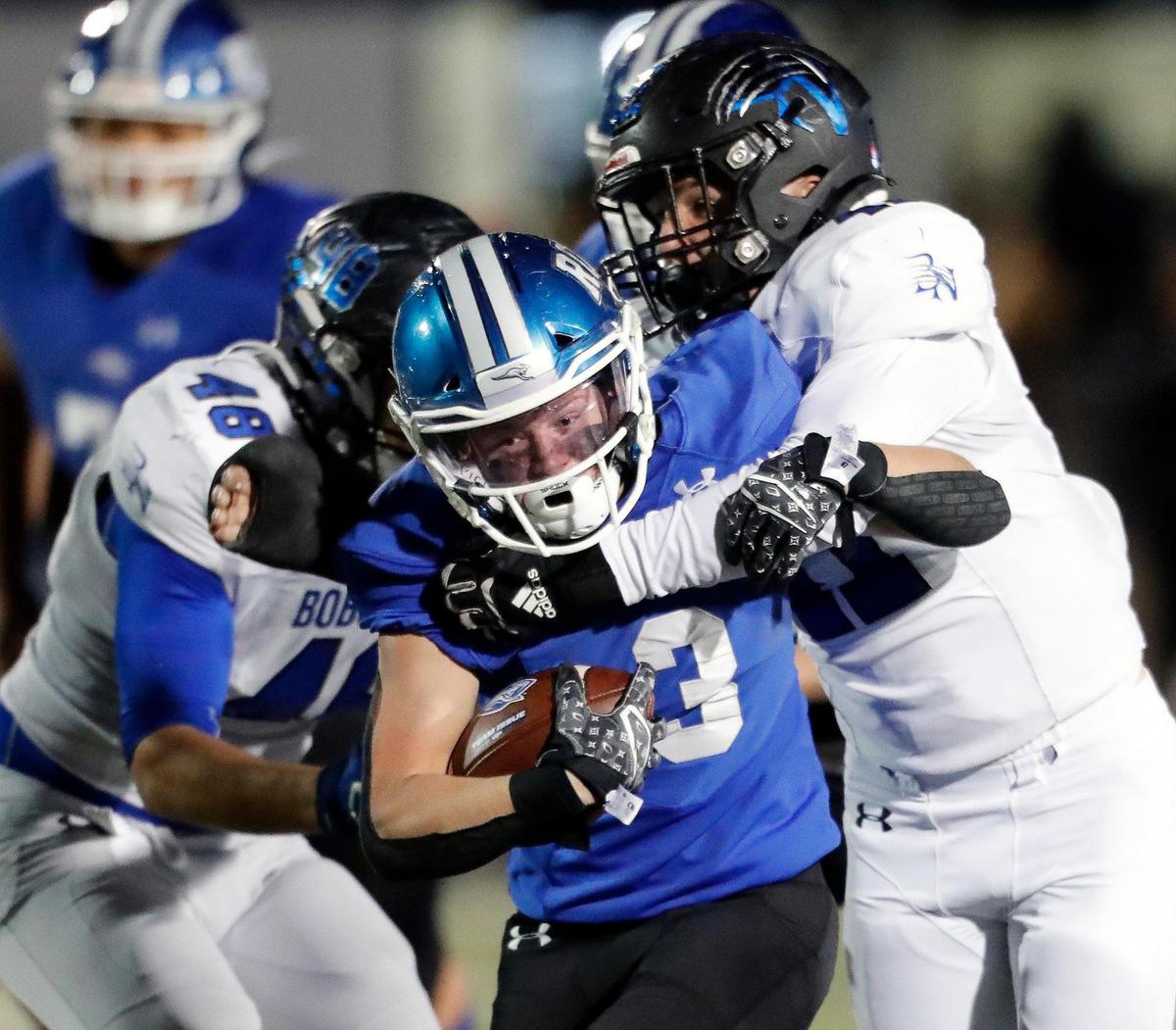 Weatherford running back Brayden Bork (3) runs into the defense of Byron Nelson’s Cade Youngs (47) and Gavin Roark (48) in a 6A Division 2 bi-district football playoff game at Kangaroo Stadium in Weatherford, Texas, Friday Nov. 12, 2021. Byron Nelson led 21-7 at the half. (Special to the Star-Telegram Bob Booth)
