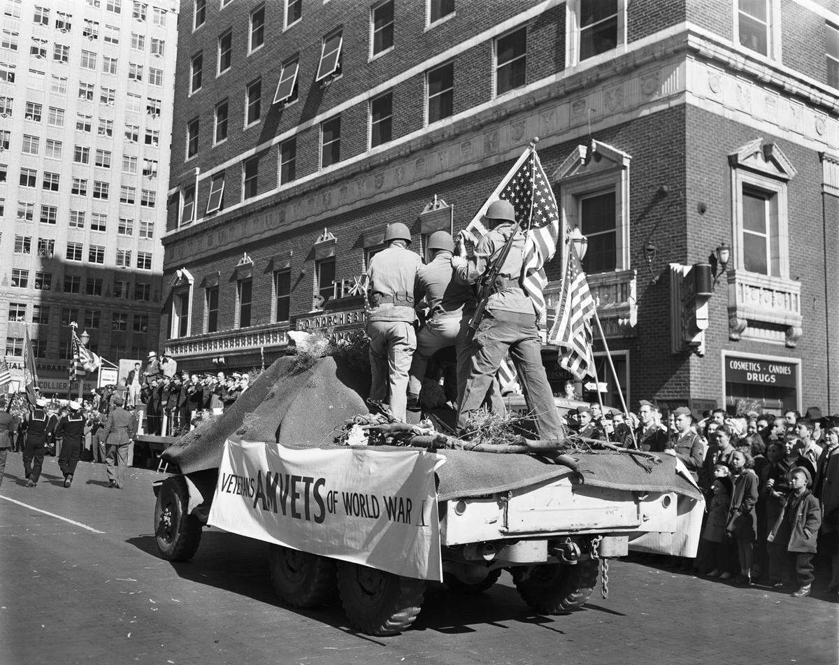 Veterans of World War II on a float at the Fort Worth Armistice Day Parade Nov. 11, 1947, reenact Joe Rosenthal’s famous flag raising photograph. The Associated Press photographer captured the iconic image as Marines raised the American flag on top of Mount Suribachi after the Battle of Iwo Jima.
