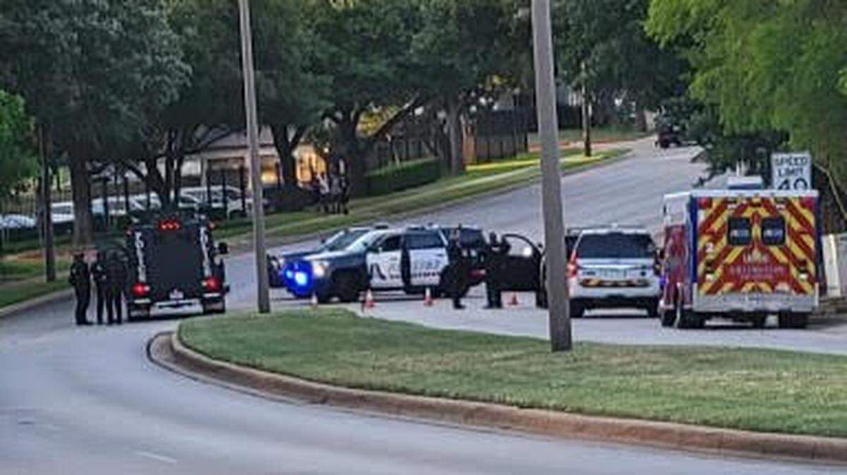 Police block off Fielder Road in Arlington, Texas, on Monday, June 6, 2022, while investigating shots fired at an apartment complex. A man was dead from an apparently self-inflicted gunshot wound after a bullet entered his neighbor’s apartment.