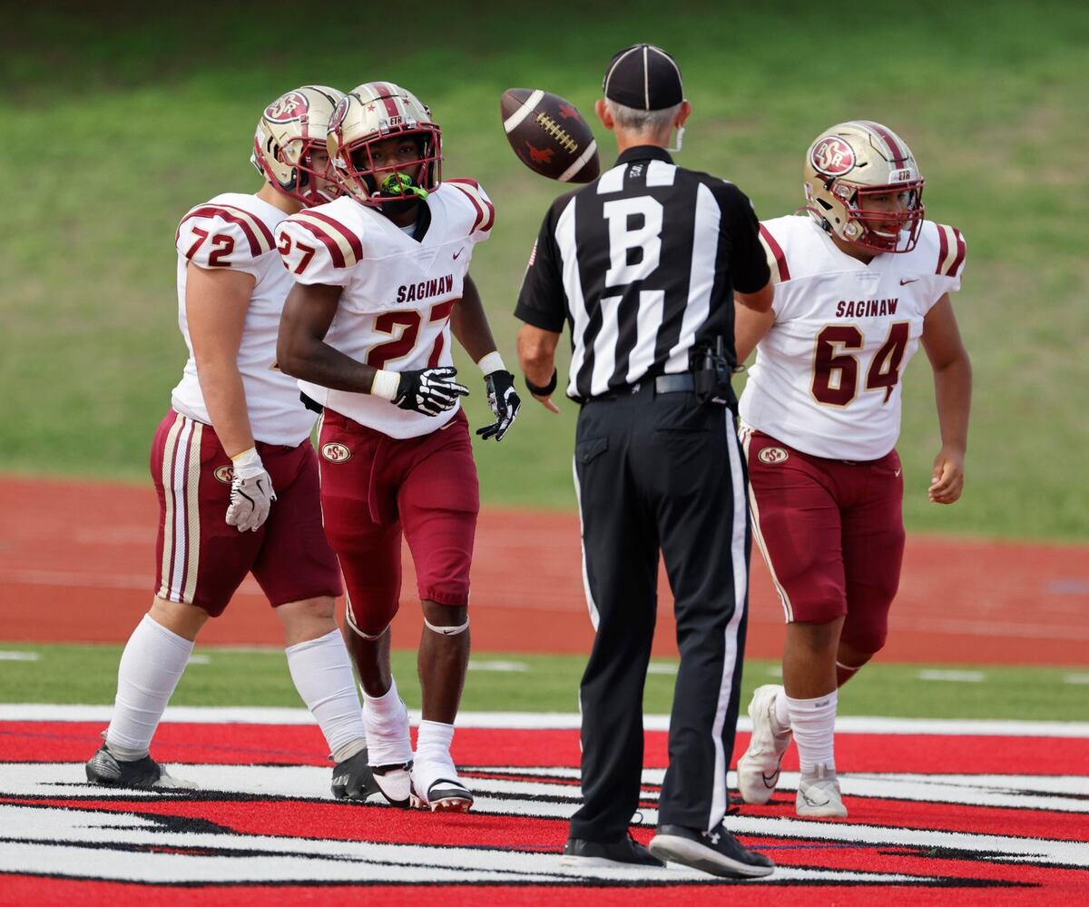 Saginaw running back Reginald Ryan (27) tosses the ball to backfield judge Paul Smith after scoring during a UIL football game at Farrington Field in Fort Worth Saturday, Sept. 14, 2024.