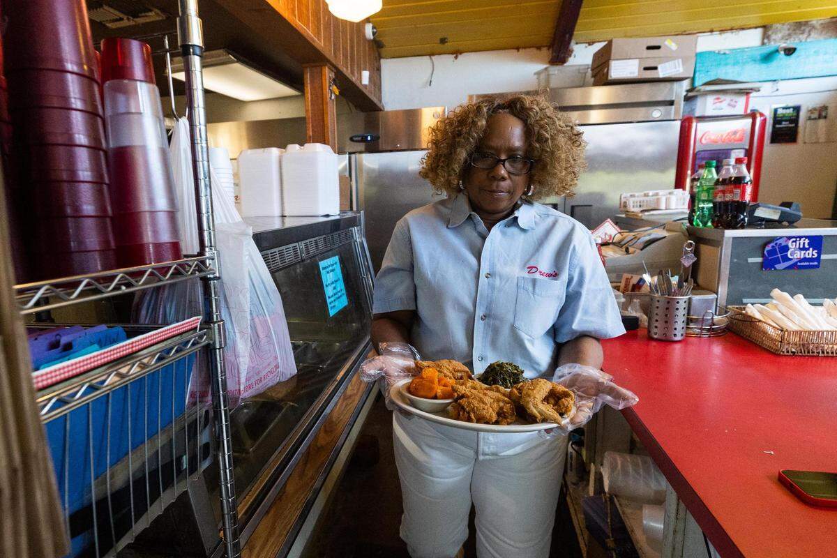 Owner Stephanie Thomas carried out a fried chicken plate at Drew’s Place in Fort Worth.