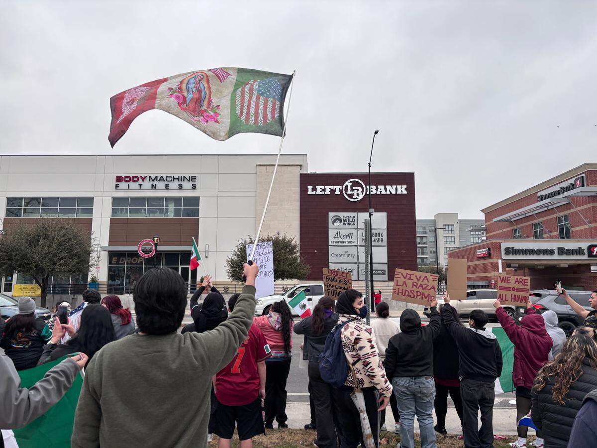 A protester waves a flag at a demonstration against deportations and family separation in Fort Worth on Sunday, Jan. 26, 2025.