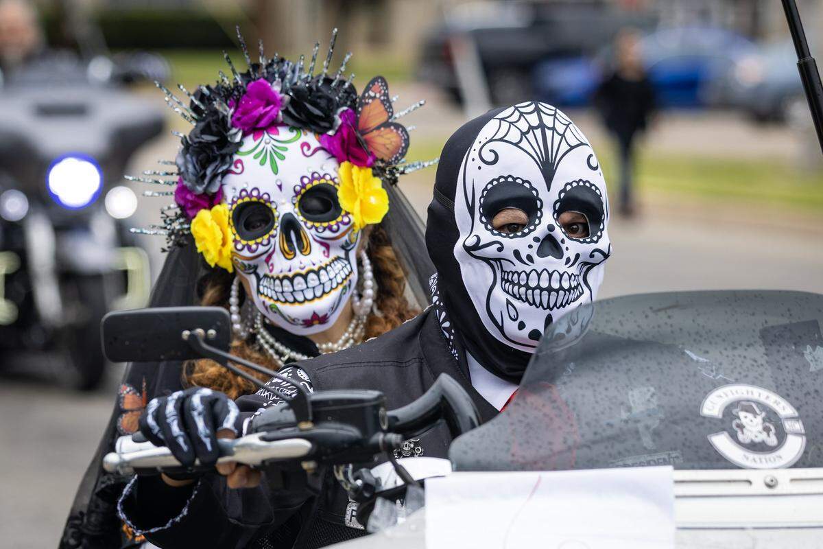 Parade participants ride down Ellis Avenue for the Dia De Los Muertos Parade in Northside Fort Worth on Saturday, Nov. 1, 2025.