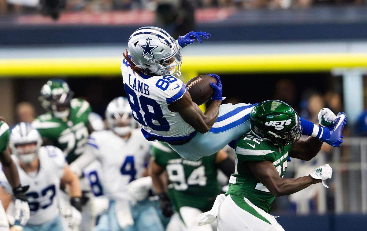 Dallas Cowboys wide receiver CeeDee Lamb flips over the back of New York Jets safety Tony Adams after leaping for a catch on Sunday, September 17, 2023, at AT&T Stadium in Arlington.