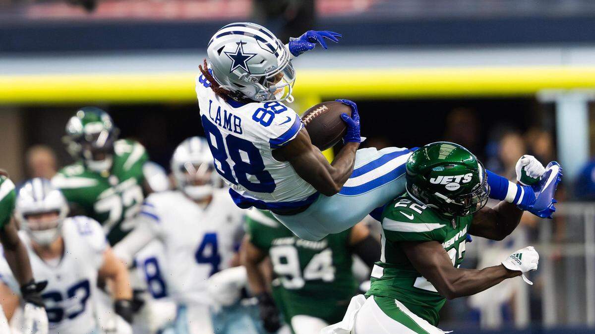 Dallas Cowboys wide receiver CeeDee Lamb flips over the back of New York Jets safety Tony Adams after leaping for a catch on Sunday at AT&T Stadium.