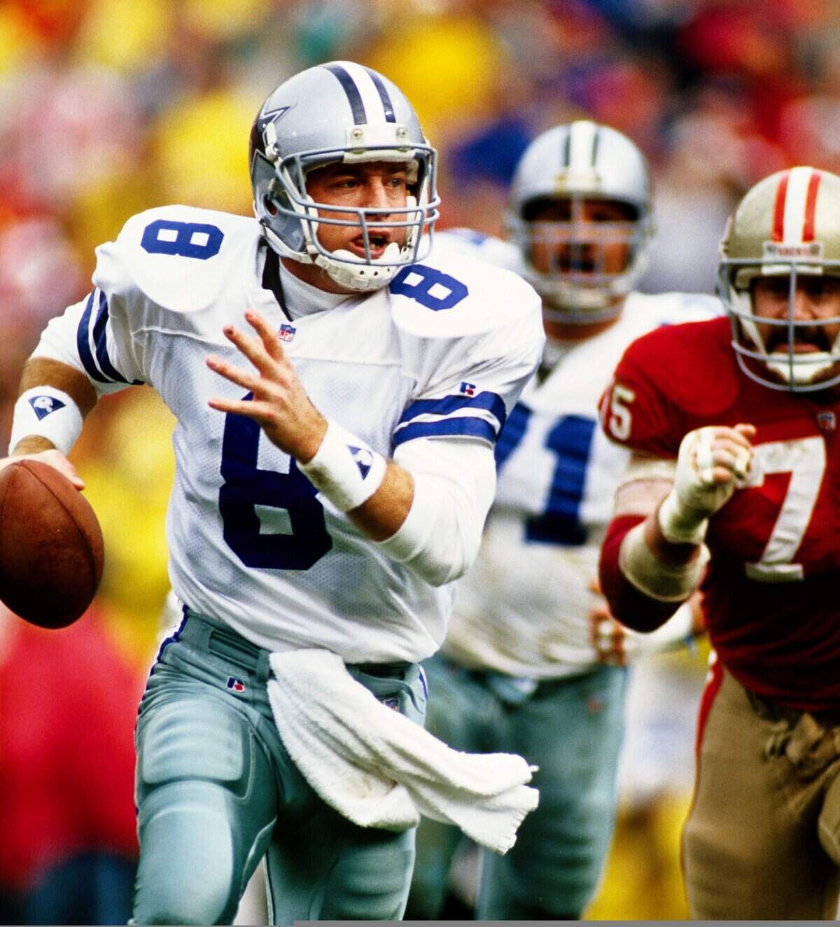 Jan 17, 1993; San Francisco, CA, USA; FILE PHOTO; Dallas Cowboys quarterback Troy Aikman (8) scrambles under pressure from San Francisco 49ers defensive end Kevin Fagan (75) during the 1992 NFC Championship game at Candlestick Park. Mandatory Credit: Peter Brouillet-USA TODAY NETWORK