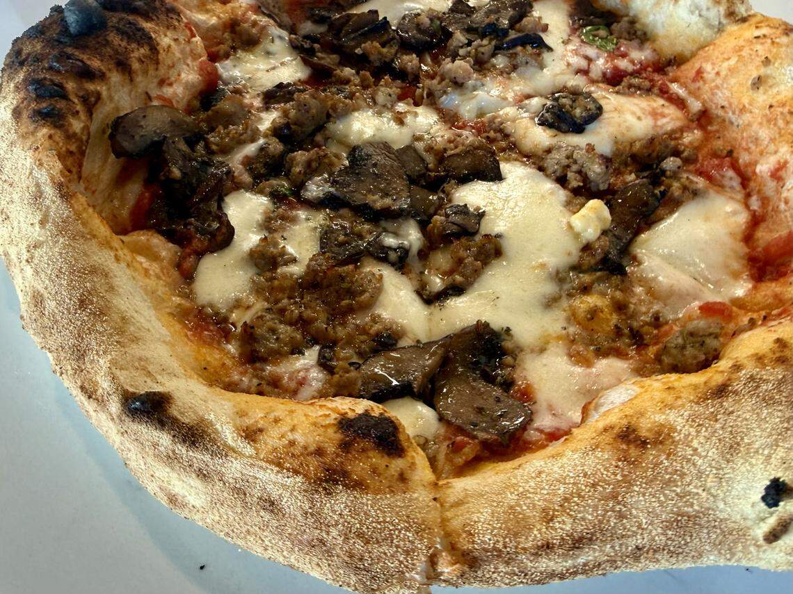 A sausage-and-mushroom pizza at Acquario Pizza Pasta + Bar in Keller, Texas, seen March 2, 2026.