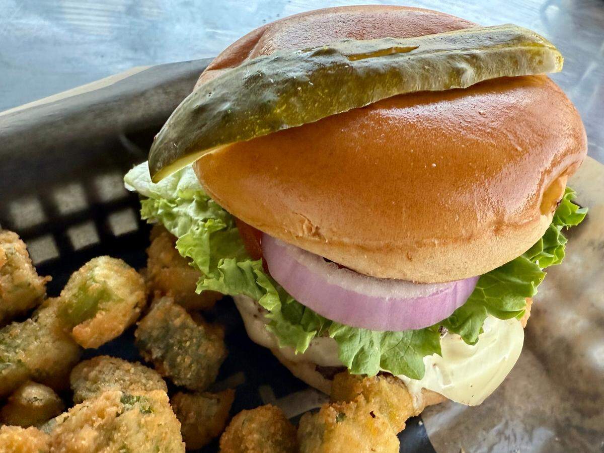 A double cheeseburger basket with a choice of 18 different side dishes (here, fried okra) is a Monday special at the Purple Frog, as seen March 10, 2025.