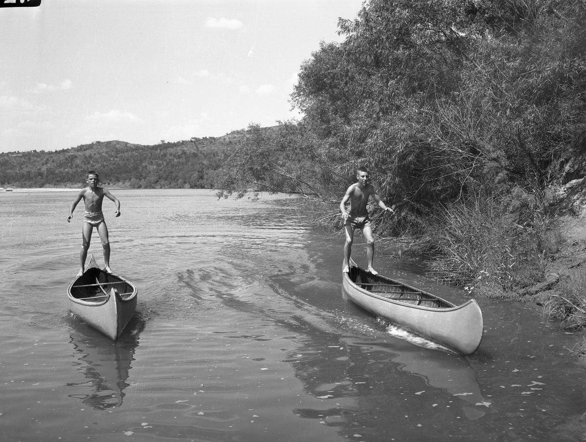 July 4, 1943: Pat O’Hara and Bill O’Grady, crew captains, illustrate finer points of “gunnel jumping” at Worth Ranch Boy Scout camp.