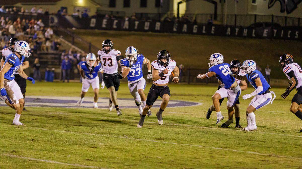 Springtown’s Chase Thompson (5) runs through Decatur defenders during a 41-38 double-overtime victory in their annual showdown in 2024. The Porcupines beat the Eagles again Friday, 63-36, to capture a second straight District 5-4A Division I championship.