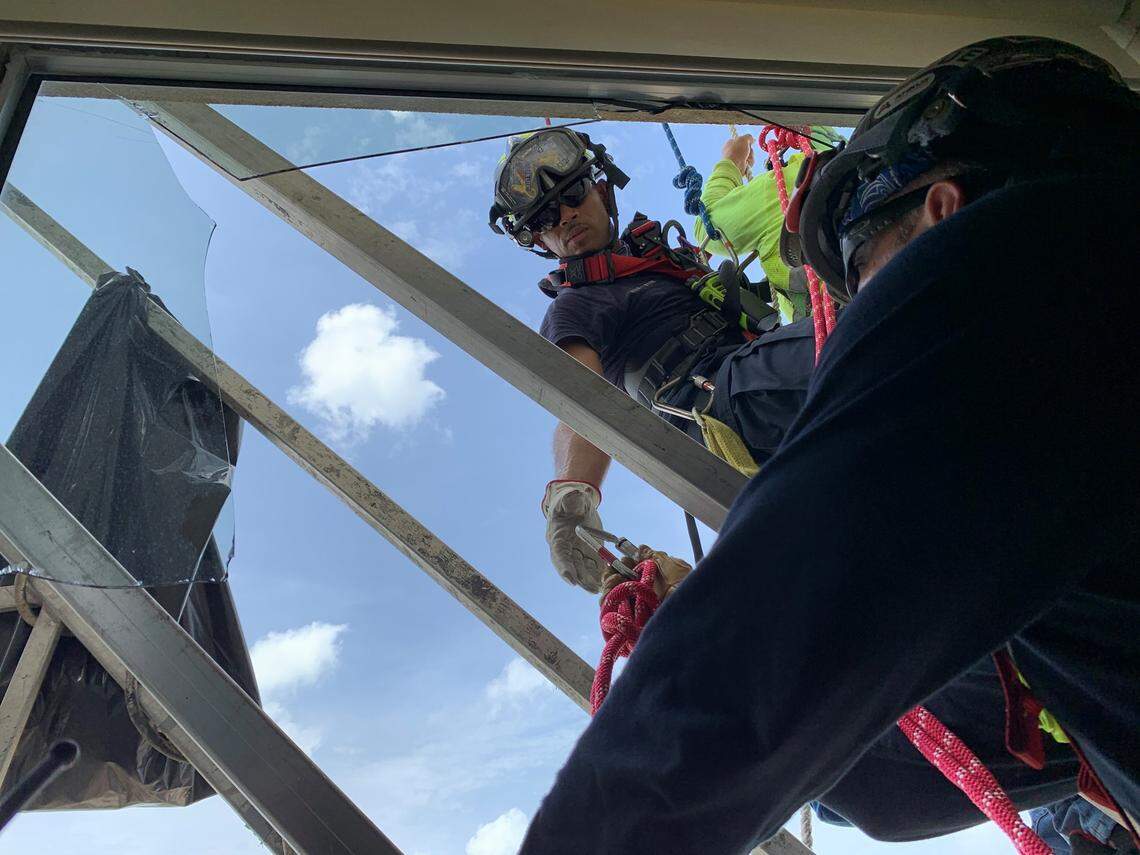 Rescuers had to cut out a window below the platform in order to pull the washers to safety.
