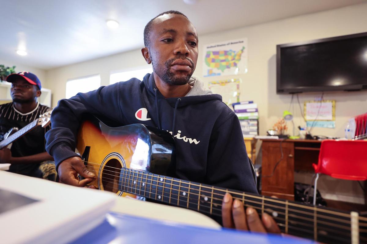 Eca Kimba plays guitar during Refugee Music Collaborative, part of Refugee Services of Texas, Saturday, Dec. 4, 2021, in Fort Worth.