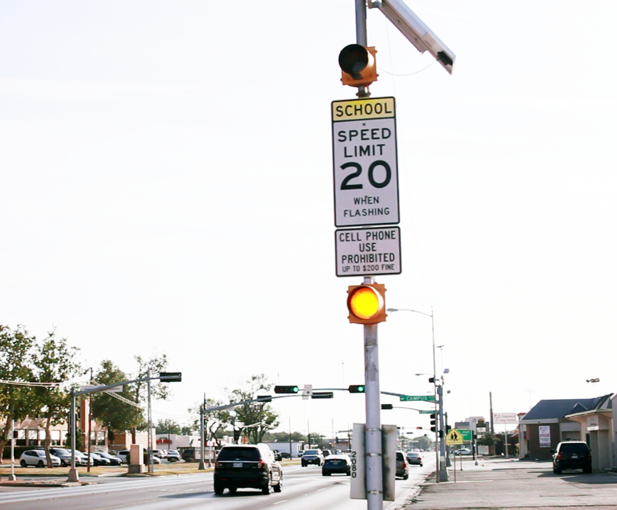 School zone speed limit sign is hard to miss with it’s bright yellow accents and flashing lights.