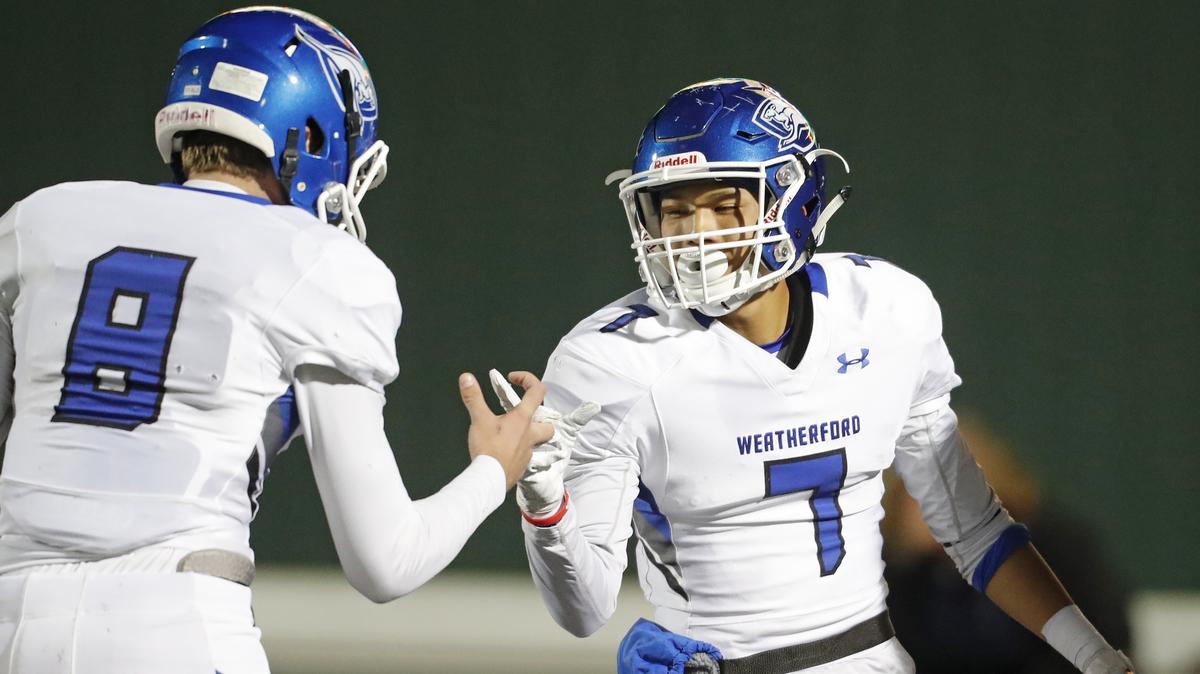 Weatherford quarterback Ken Seals (8) celebrates wide receiver Rey Huang’s (7) touchdown during the first half of a high school football game at Pennington Field in Euless, Texas, Friday, Nov. 09, 2018. Seals threw three TD passes Friday night as the Kangaroos defeated L.D. Bell 31-21 at Kangaroo Stadium.