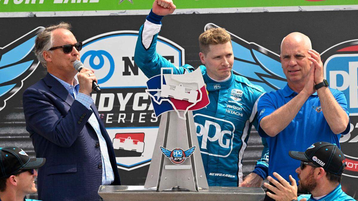 Team Penske driver Josef Newgarden (2) of United States celebrates with the trophy in victory lane after he wins the NTT IndyCar Series PPG 375 under yellow caution at Texas Motor Speedway. Mandatory Credit: Jerome Miron-USA TODAY Sports
