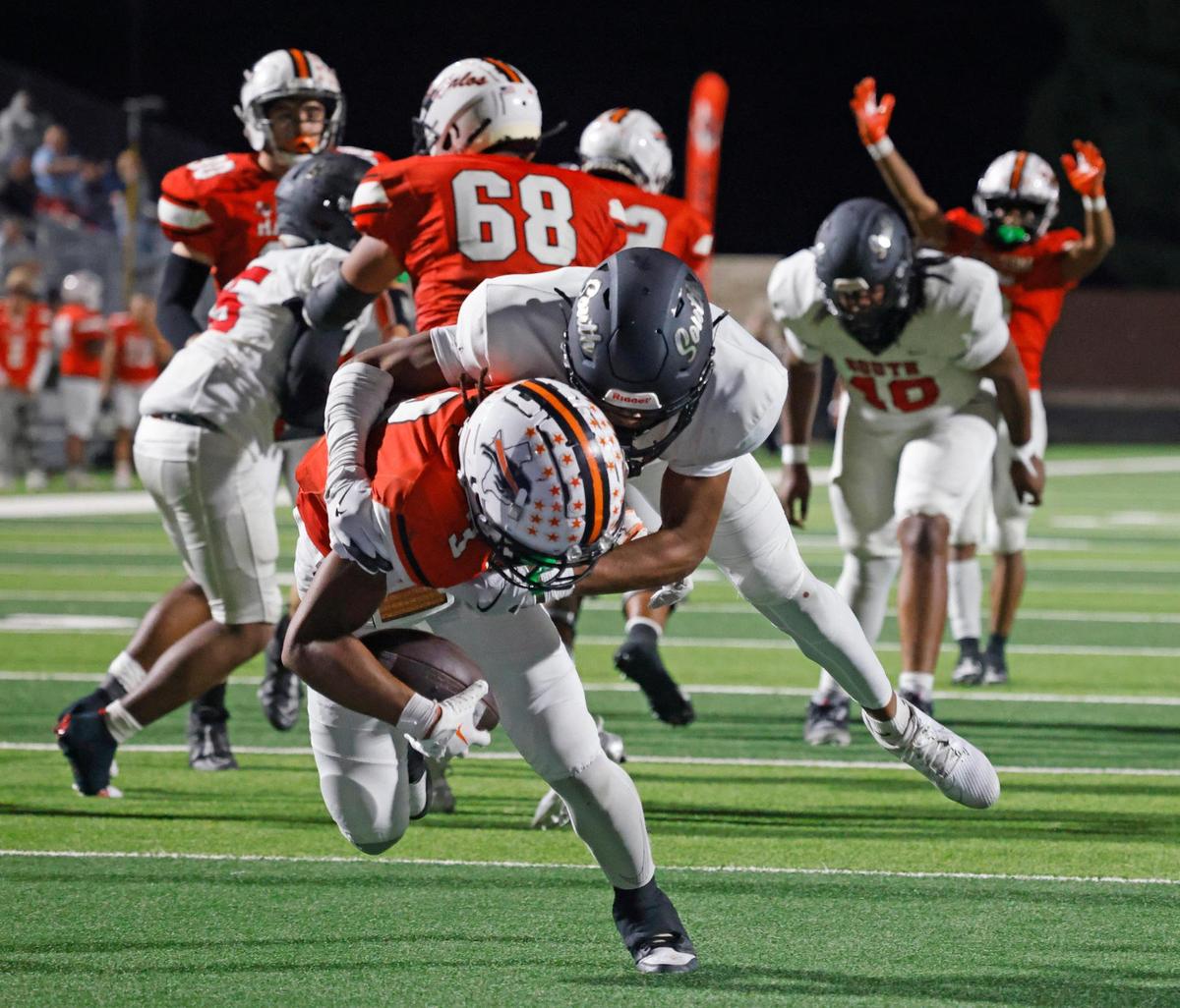 Haltom running back Keenan Jackson (3) carried South Grand Prairie defensive back Cade Wallace (2) six yards into the end zone during a UIL District 8-6A football game at Birdville Fine Arts/Activity Complex in North Richland Hills, Texas, Thursday, Oct. 31, 2024.