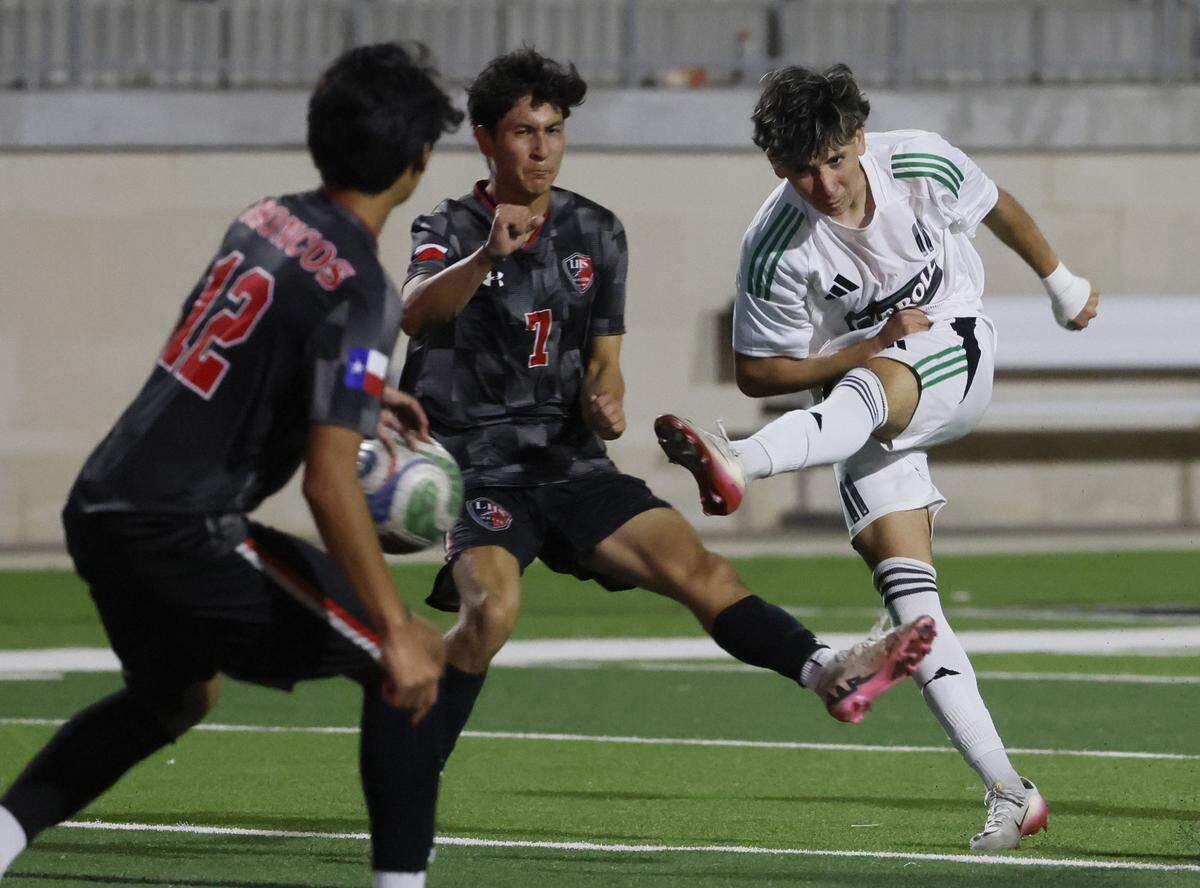 Southlake Carroll’s Jad Shehadeh kicks the ball between Mansfield Legacy midfielder Joseph Murillo and defender Alan Mendiola during the first half of a UIL bi-district round soccer playoff game at Crowley ISD Multi-Purpose Stadium in Fort Worth, Texas, on Friday, March 20, 2026.