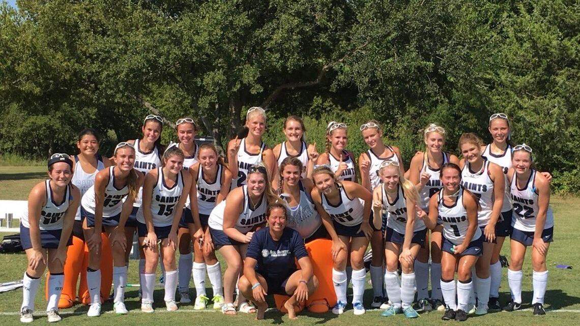 The All Saints girls field hockey team celebrate coach Dana Weaver's 100th career win in September.