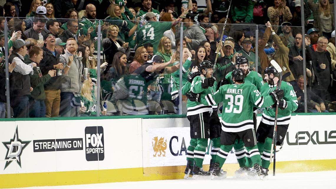 Dallas Stars center Mattias Janmark (13) celebrates with teammates after scoring a goal against the San Jose Sharks during the second period of an NHL hockey game Friday, Dec. 7, 2018, in Dallas. (AP Photo/Cooper Neill)
