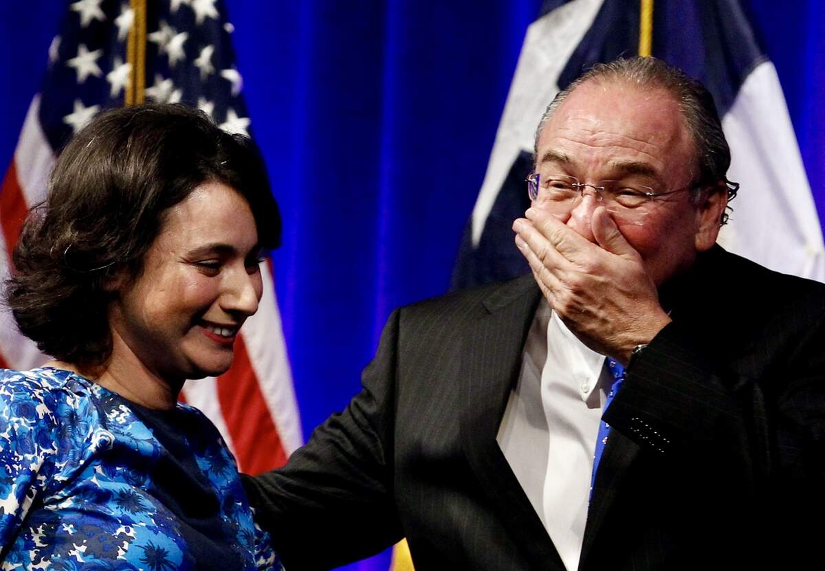 Gina Hinojosa walks off stage with her father, Texas Democratic Party Chairman Gilberto Hinojosa, as he laughs at the Texas Democratic Party state convention June 27, 2014, at the Kay Bailey Hutchison Convention Center in Dallas, Texas.