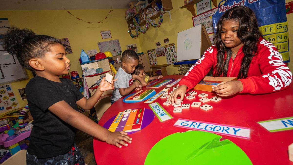 Students Bryson Harley, 5, Tobeena Emedosi, 3, and Layla Alston, 4, learn number patterns from their teacher Kennedy Chaney in the evening at the Future Scholars’ Childcare and Transportation child care home in Grand Prairie on Thursday, March 14, 2024. Future Scholars’ is one of few options in Tarrant County that provide 24/7 child care.