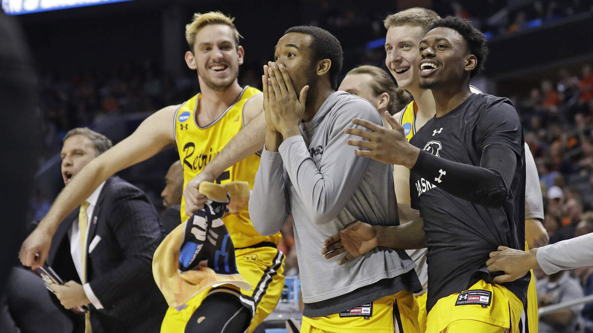 UMBC players celebrate a teammate's basket against Virginia during the second half of their first-round upset of top-ranked Virginia in Friday's first-round game in the NCAA men's college basketball tournament in Charlotte, N.C.