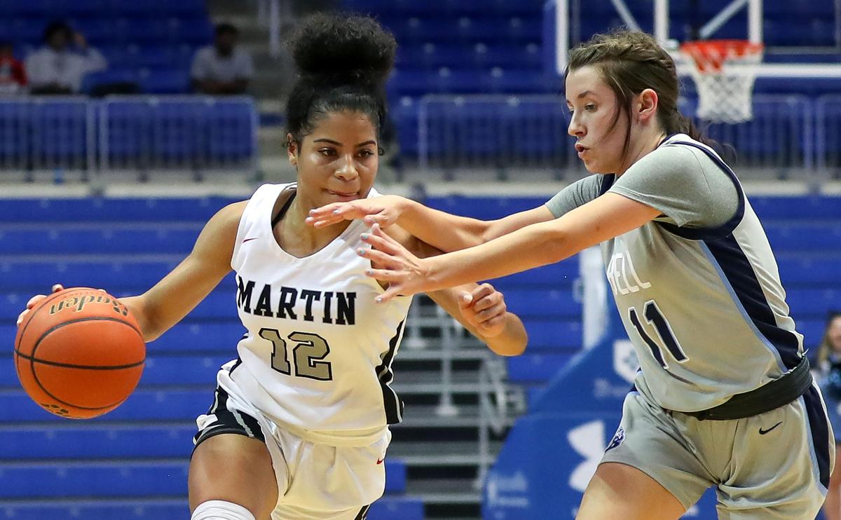 Arlington Martin guard Autumn Smith (12) tries to dribble past L.D. Bell guard Macey Mercer (11) during the second half of the Girls Regional Quarterfinal Playoff basketball game, Tuesday, February 25, 2020 at the College Park Center on the UTA campus in Arlington, Texas.