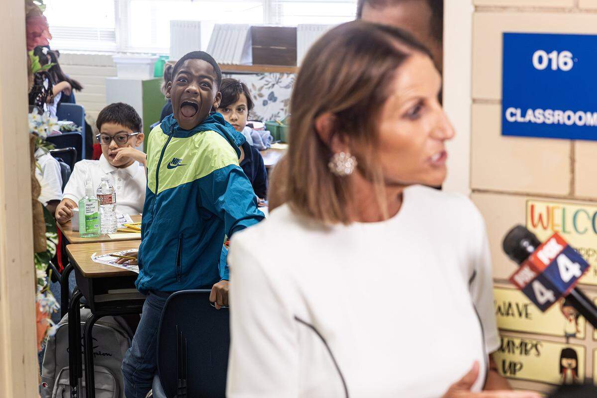 One of Zoe Willey's reading students photobomb Fort Worth ISD Superintendent Karen Molinar while she's being interviewed by the media during the first day of instruction at Mary Louise Phillips Elementary School in Fort Worth on Tuesday, Aug. 12, 2025.