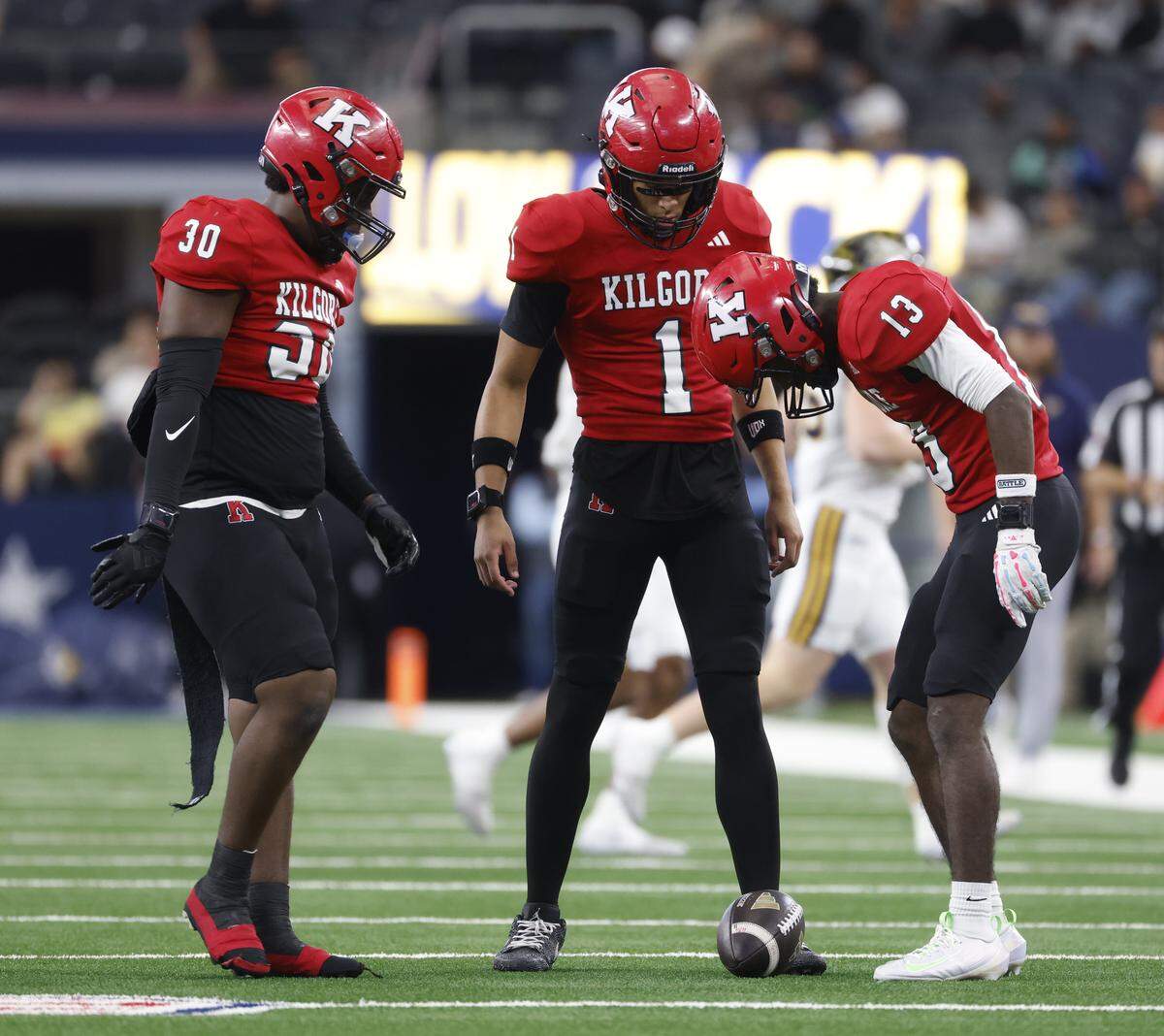 Kilgore defensive lineman Zarak Hall (30), wide receivers Brayden Williams (1) and Takieran White (13) watch a punt to Stephenville come to a stop during the first half of the UIL Class 4A Division I championship game on Friday Dec. 19, 2025 at AT&T Stadium in Arlington, Texas.