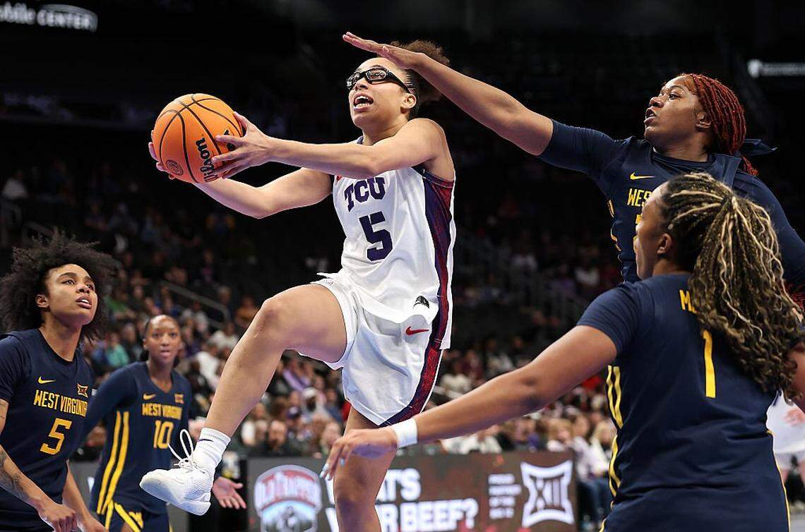 KANSAS CITY, MISSOURI - MARCH 08: Olivia Miles #5 of the TCU Horned Frogs drives to the basket as Gia Cooke #3, Sydney Shaw #5, and Carter McCray #1 of the West Virginia Mountaineers defendduring the championship game of the 2026 Big 12 Women's Tournament at T-Mobile Center on March 08, 2026 in Kansas City, Missouri. (Photo by Jamie Squire/Getty Images)