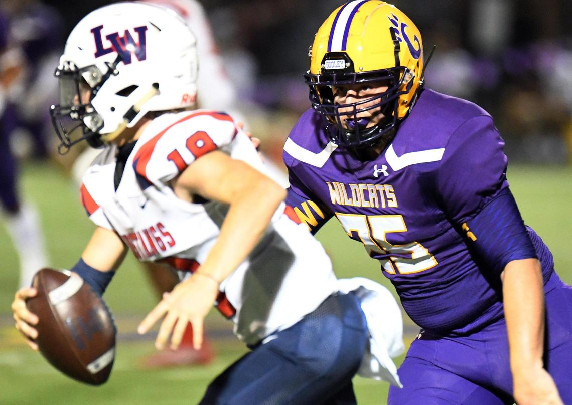 Life Waxahachie quarterback, Kaden Mayfield, left is chased out of the backfield by Godley’s Kaleb Black in the second quarter of their Friday Friday August 28, 2020 Football game in Godley, Texas. Godley led 15-3 at the end of the first half. Special/Bob Haynes