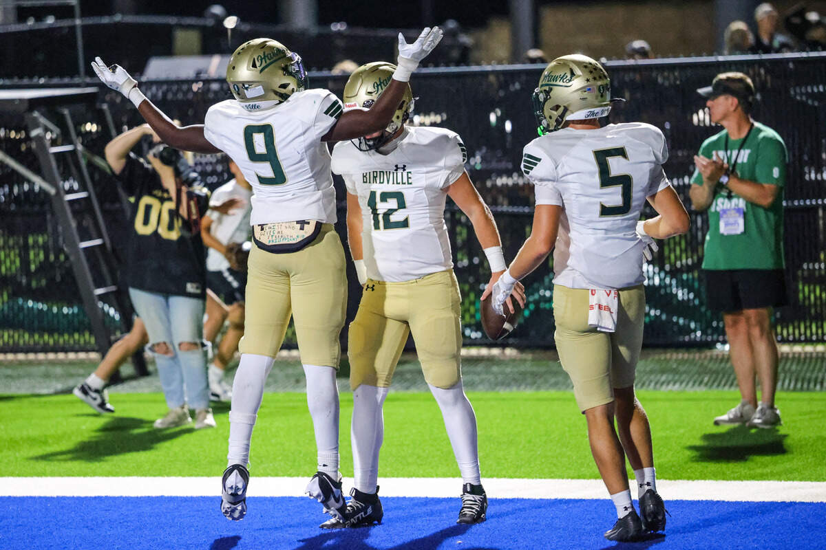 Birdville quarterback Zach Wells (12) celebrates his TD run with running back Christian Kargbo (9) and and receiver Jake Subjeck (5) in the Friday, Sept. 26 game at Birdville ISD FineArts/Athletics Complex.
