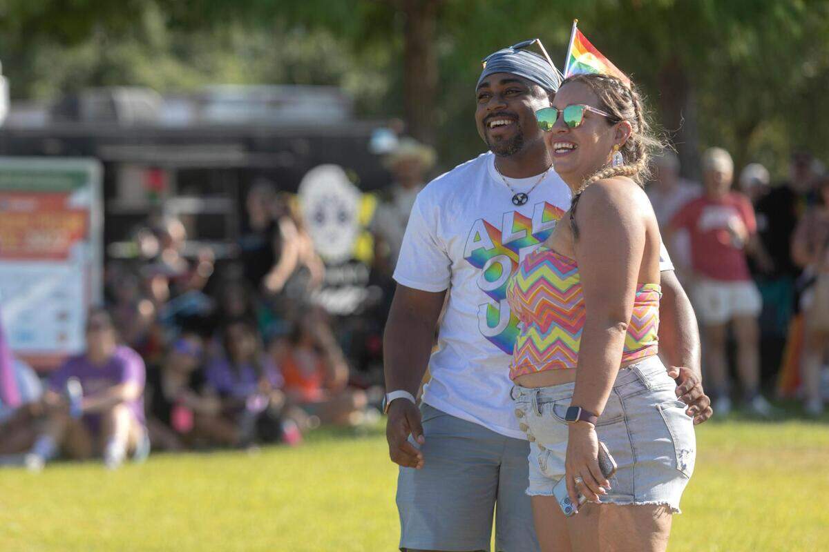 Shane Israel and Monika Camacho watch a performance during Trinity Pride at Magnolia Green Park on Saturday, June 25, 2022.