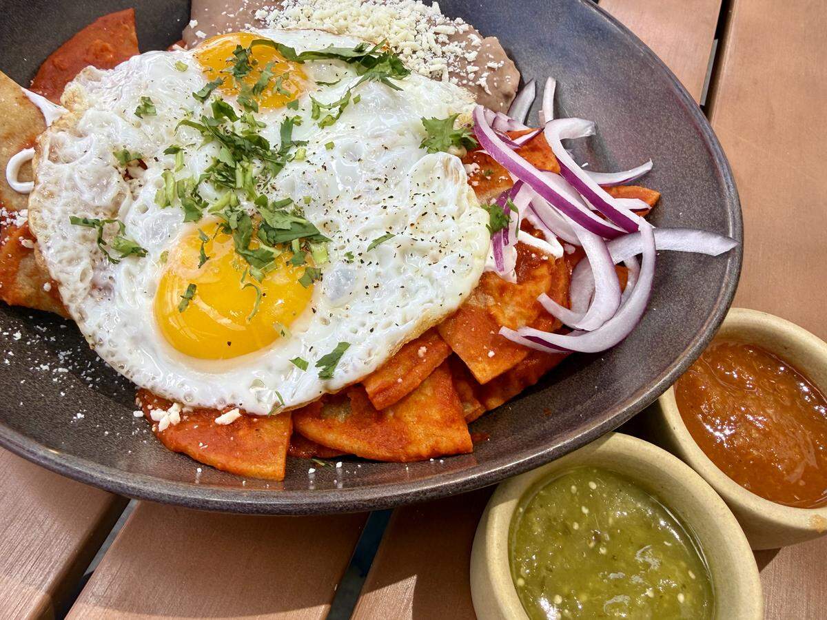 Chilaquiles rojos with eggs are on the brunch menu at Tinies restaurant in South Main Village.