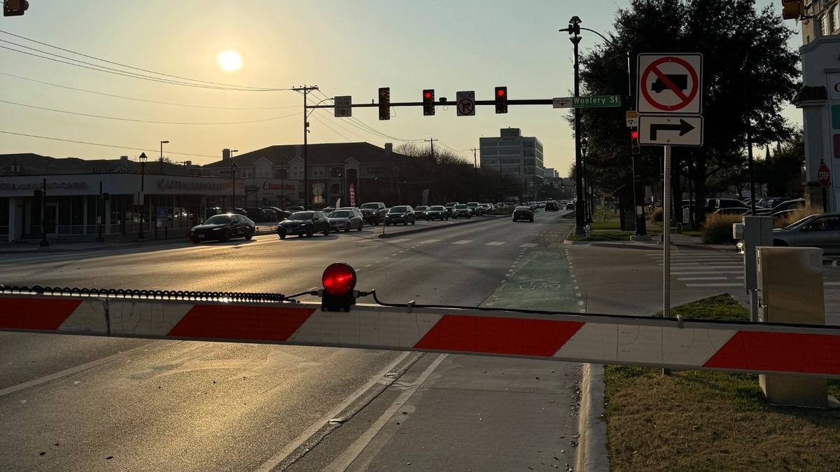 Traffic backed up along West 7th Street in early February 2025 as vehicles wait for a freight train to cross the road. Fort Worth plans to install signage at nearby intersections warning commuters of oncoming trains to ease the congestion.