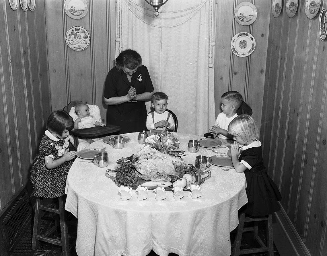 Nov. 1, 1952: Society Series on Thanksgiving table settings. “Father, We Thank Thee”: Mrs. Oliver Shannon, 1407 Grand Ave., says “grace before meat” at the children’s table, with her grandchildren, left to right: Ann Shannon Lewis, J.O. Shannon III, Joseph Stocking Lewis, Glenn W. Stewart Jr. and Judith Helen Stewart.
