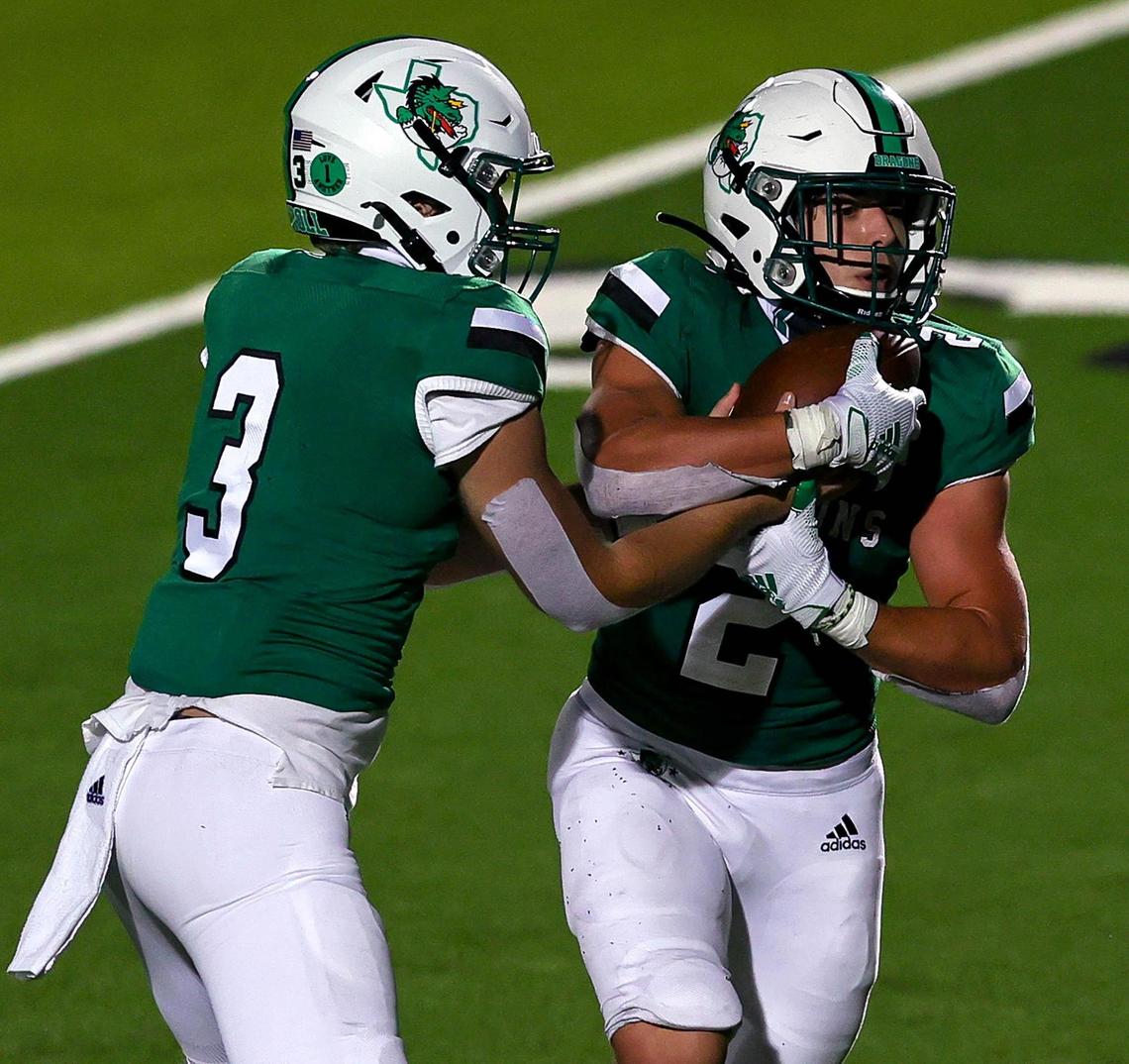 Southlake Carroll quarterback Quinn Ewers hands the ball off to running back Owen Allen (2) against Rockwall Heath during the second half of a High School Football game, Friday night, October 2, 2020 played at Dragon Stadium in Southlake, TX. (Steve Nurenberg Special to the Star-Telgram)