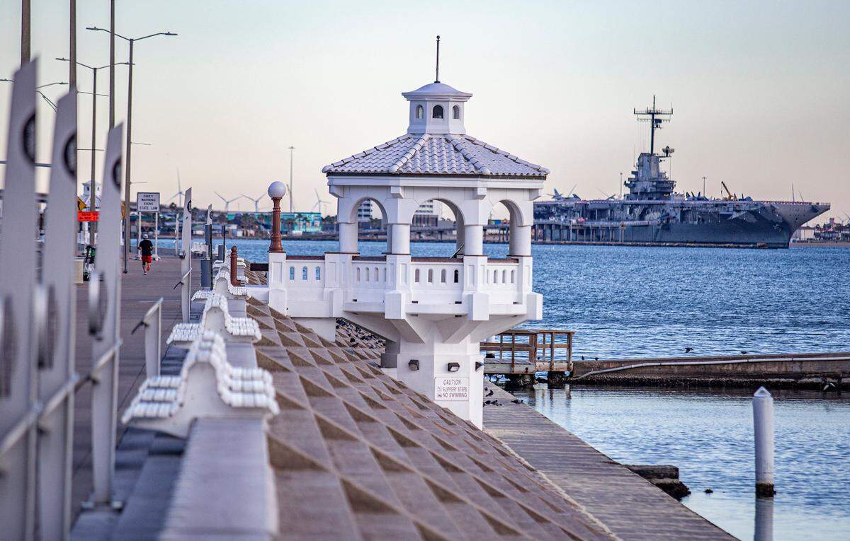 White pavilions line the seawall in Corpus Christi, Texas, Wednesday, Nov. 22, 2023. The USS Lexington museum can be seen in the background.&nbsp;